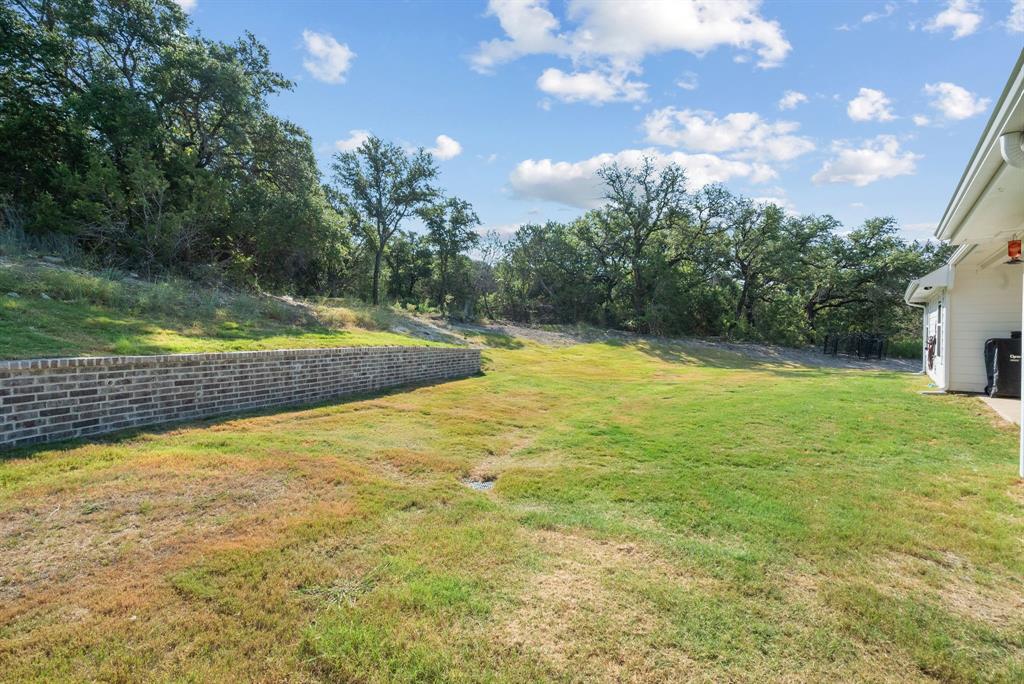 355 Sunset Cove Bluff Dale, TX 76433 - Photo 32 of 40 a view of a swimming pool with an outdoor space and seating area