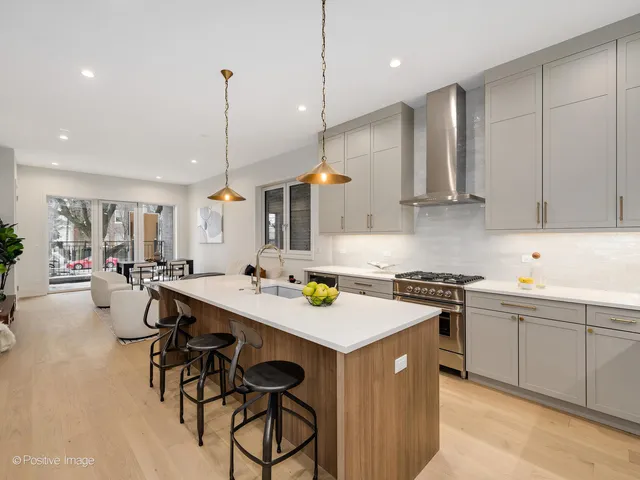 a kitchen with a stove a table and chairs in it