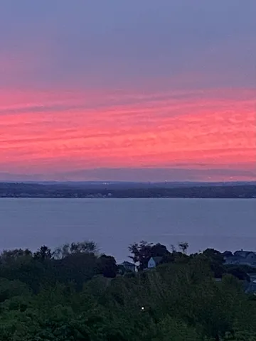 a sunset view with a lake