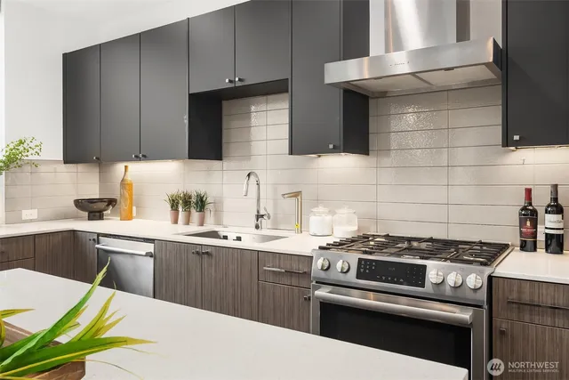 a kitchen with a sink a stove and cabinets