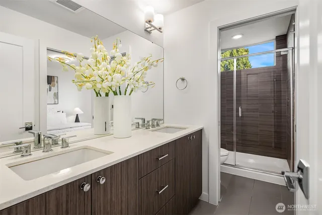 a bathroom with a sink double vanity and a mirror
