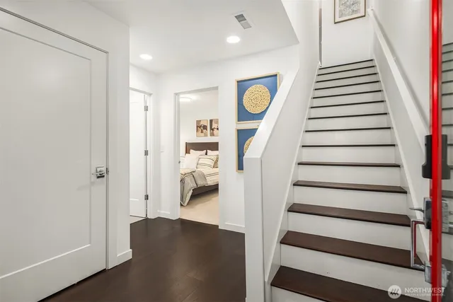 a view of entryway and hall with wooden floor