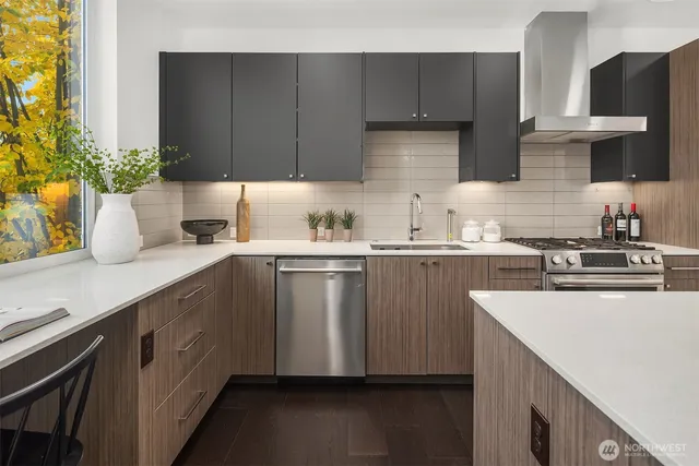 a kitchen with a sink a stove cabinets and wooden floor