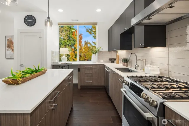 a kitchen with a stove a sink and a microwave