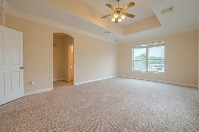 a view of a house with backyard and wooden fence