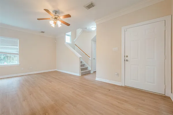wooden floor in an empty room with a window