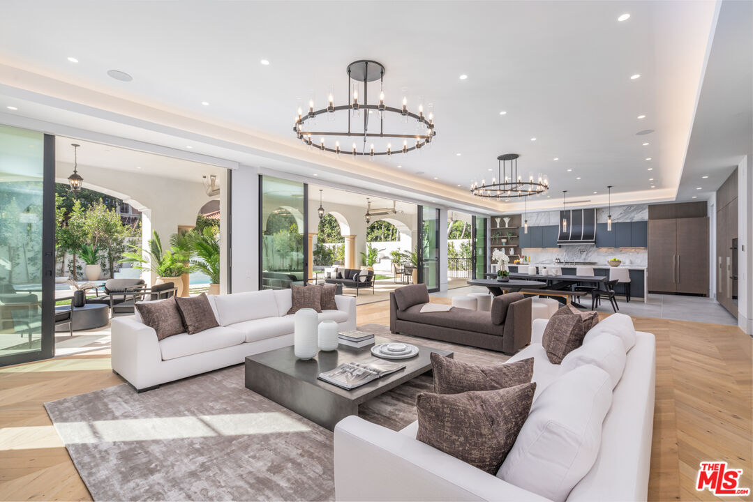 611 North Hillcrest Road Beverly Hills, CA 90210 - Photo 13 of 65 a living room with furniture floor to ceiling window and wooden floor