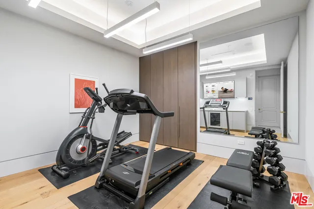 a bedroom with a bed a mirror and a table