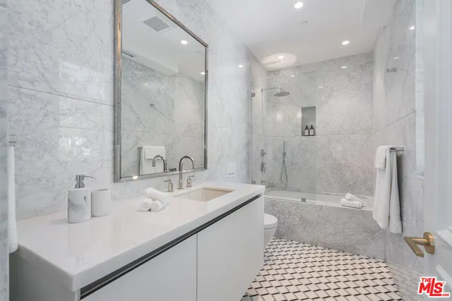 a view of a living room and bathroom with a tub