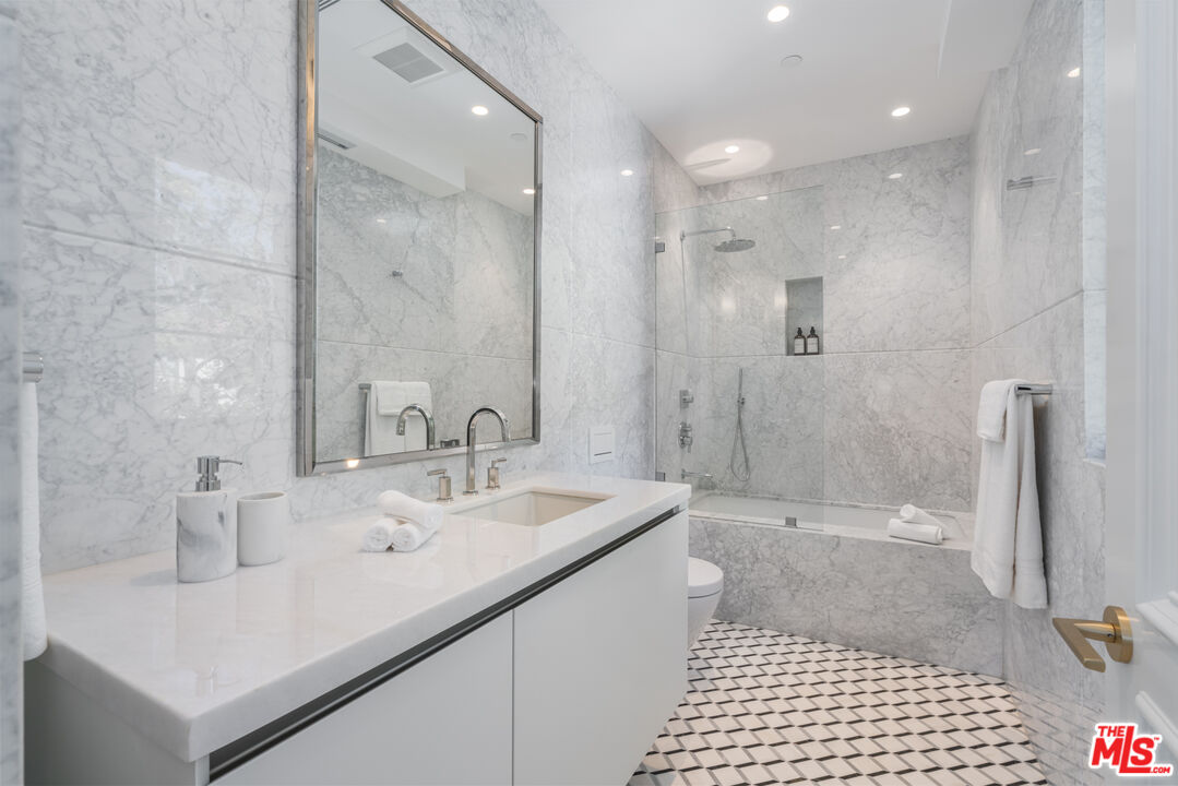 611 North Hillcrest Road Beverly Hills, CA 90210 - Photo 47 of 65 a bathroom with a sink a shower and a mirror