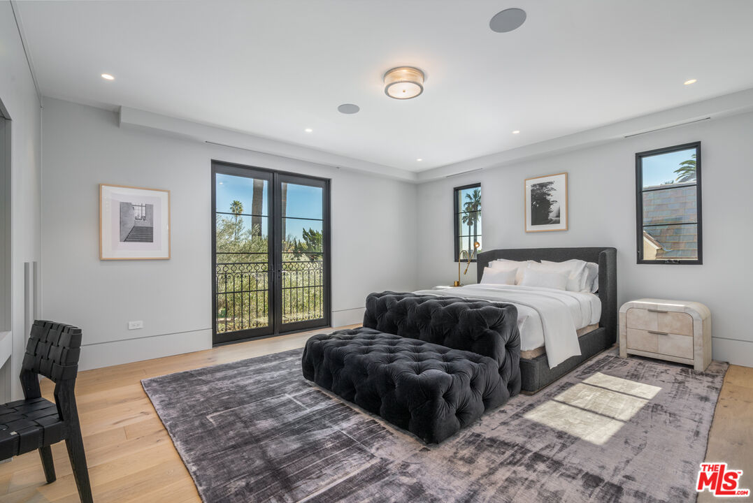 611 North Hillcrest Road Beverly Hills, CA 90210 - Photo 48 of 65 a bedroom with a large bed and a window