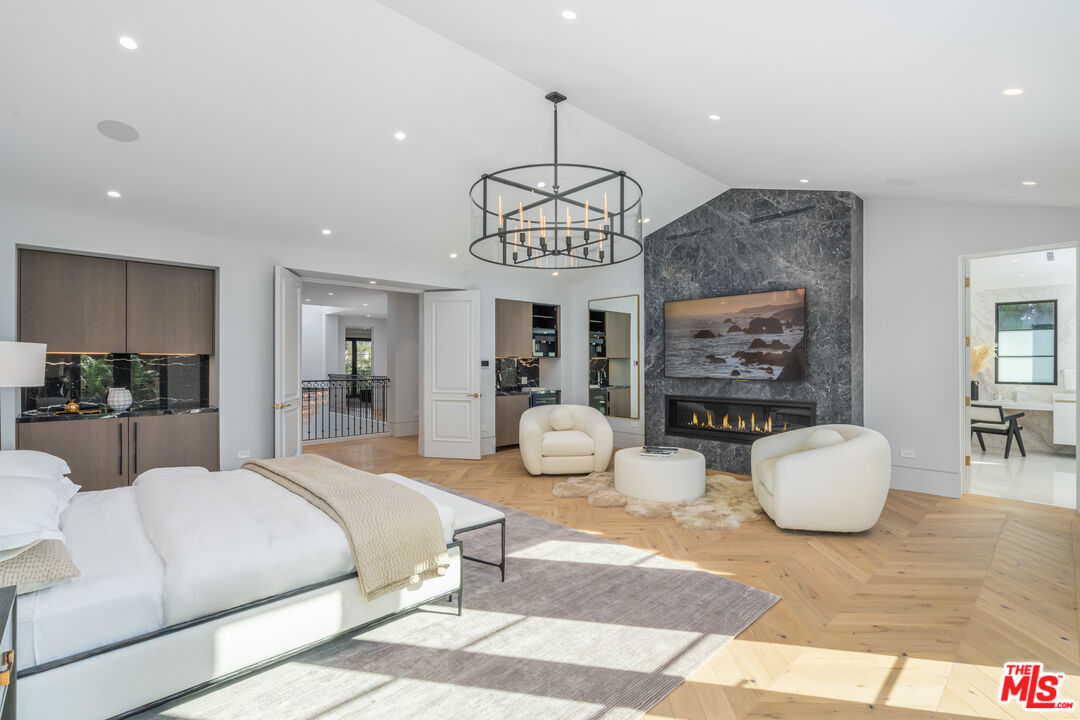 611 North Hillcrest Road Beverly Hills, CA 90210 - Photo 53 of 65 a bedroom with furniture and a chandelier