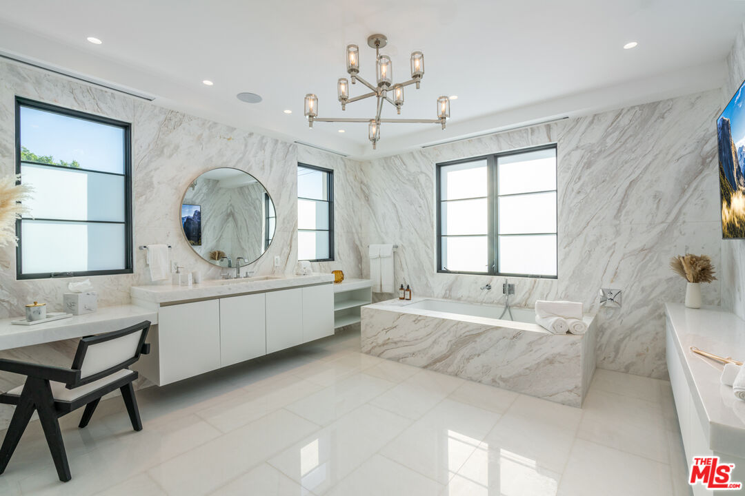 611 North Hillcrest Road Beverly Hills, CA 90210 - Photo 54 of 65 a large spacious bathroom with a large tub sink and window