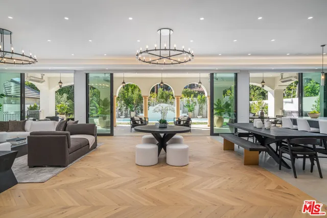 a living room with fireplace furniture and a large window