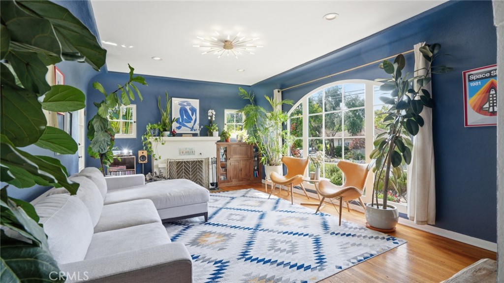 a living room with fireplace furniture and a large window