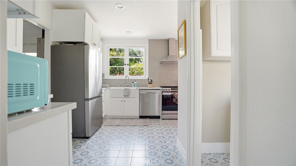 270 Clinton Street Pasadena, CA 91103 - Photo 26 of 75 a kitchen with a refrigerator sink stove and cabinets