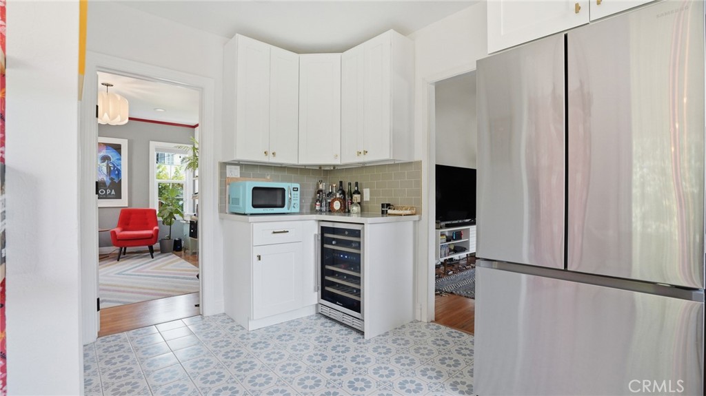 270 Clinton Street Pasadena, CA 91103 - Photo 30 of 75 a kitchen with a refrigerator a stove and white cabinets