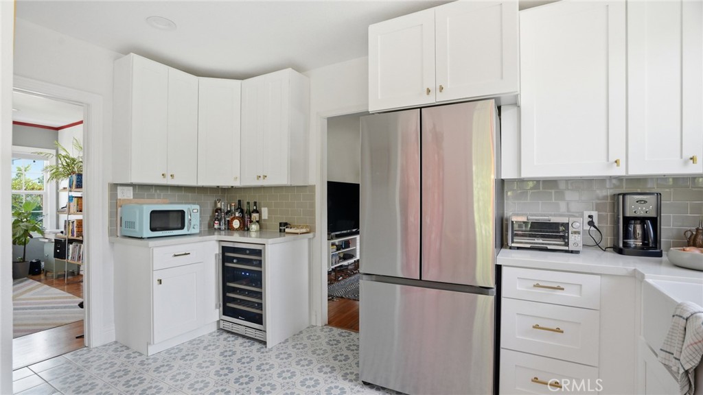 270 Clinton Street Pasadena, CA 91103 - Photo 31 of 75 a kitchen with white cabinets and stainless steel appliances