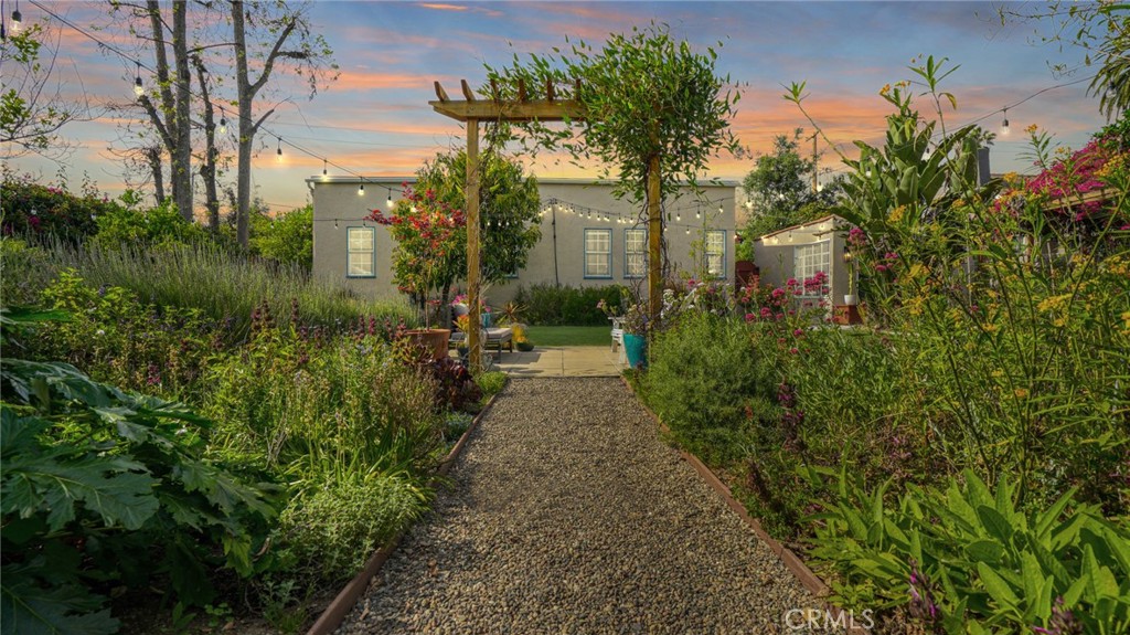 270 Clinton Street Pasadena, CA 91103 - Photo 65 of 75 a view of a pathway with flower plants and large trees