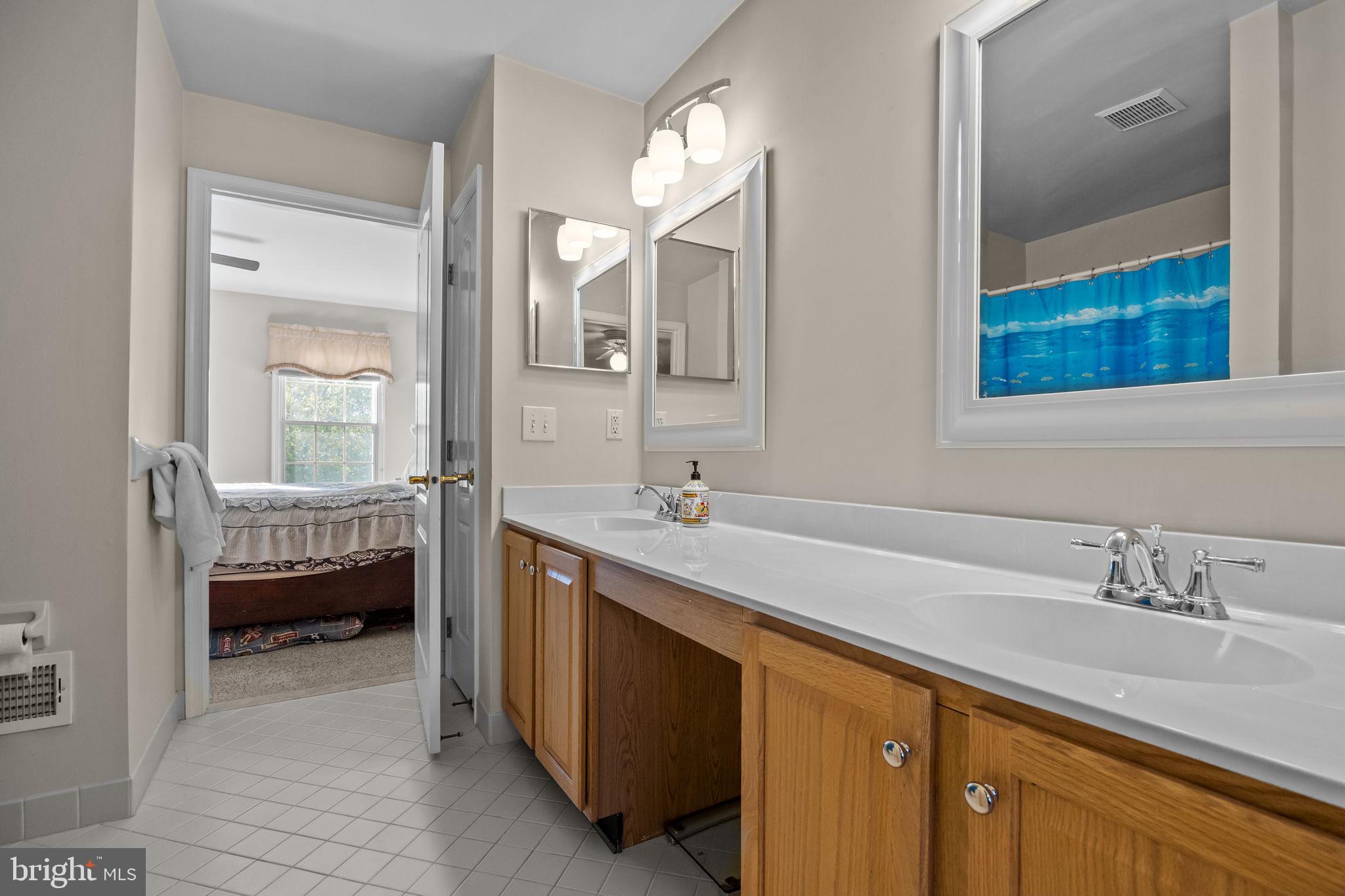 3689 Hancock Lane Doylestown, PA 18902 - Photo 34 of 78 a en suite bathroom with a double vanity sink and a mirror