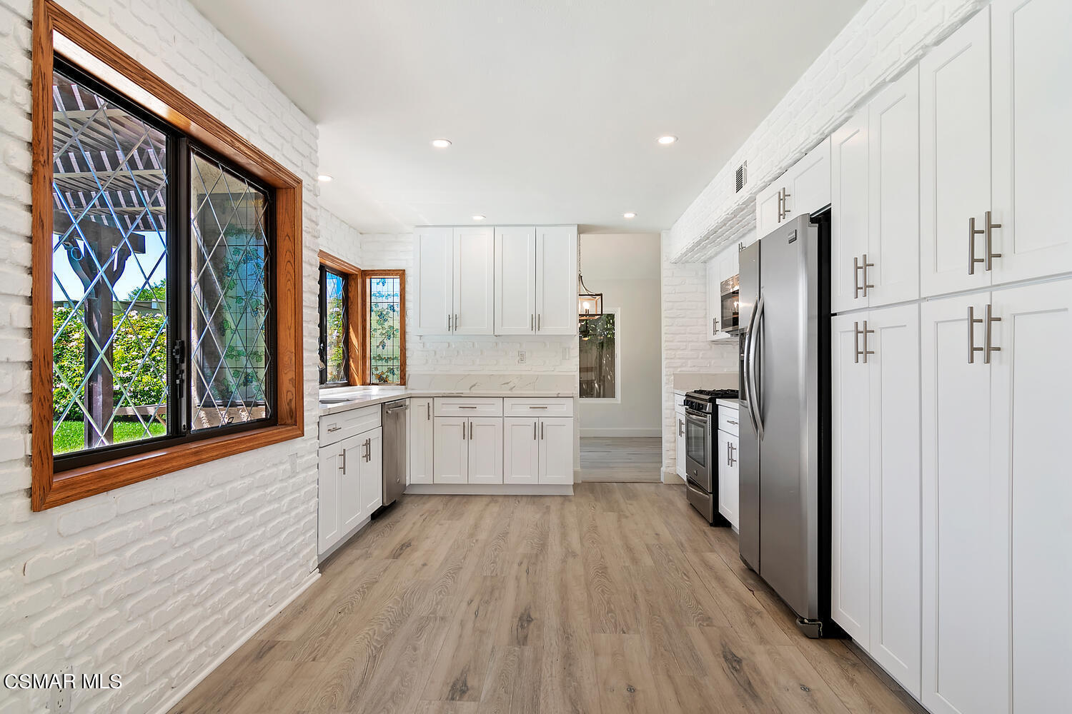 224 Cedar Heights Drive Thousand Oaks, CA 91360 - Photo 13 of 27 a kitchen with stainless steel appliances a refrigerator and wooden floor