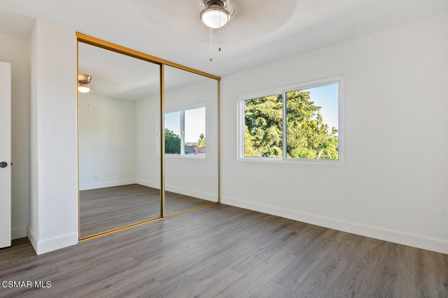 224 Cedar Heights Drive Thousand Oaks, CA 91360 - Photo 18 of 27 an empty room with wooden floor and windows