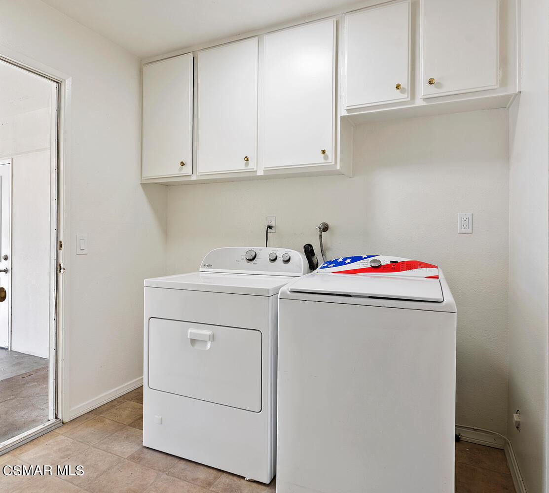 224 Cedar Heights Drive Thousand Oaks, CA 91360 - Photo 22 of 27 a utility room with cabinets washer and dryer