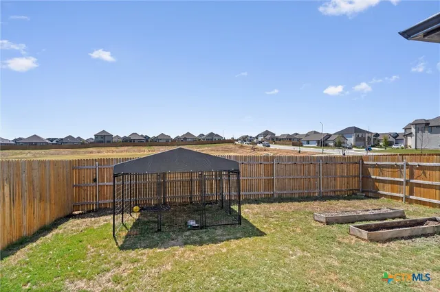 a view of a lake with a house and a big yard