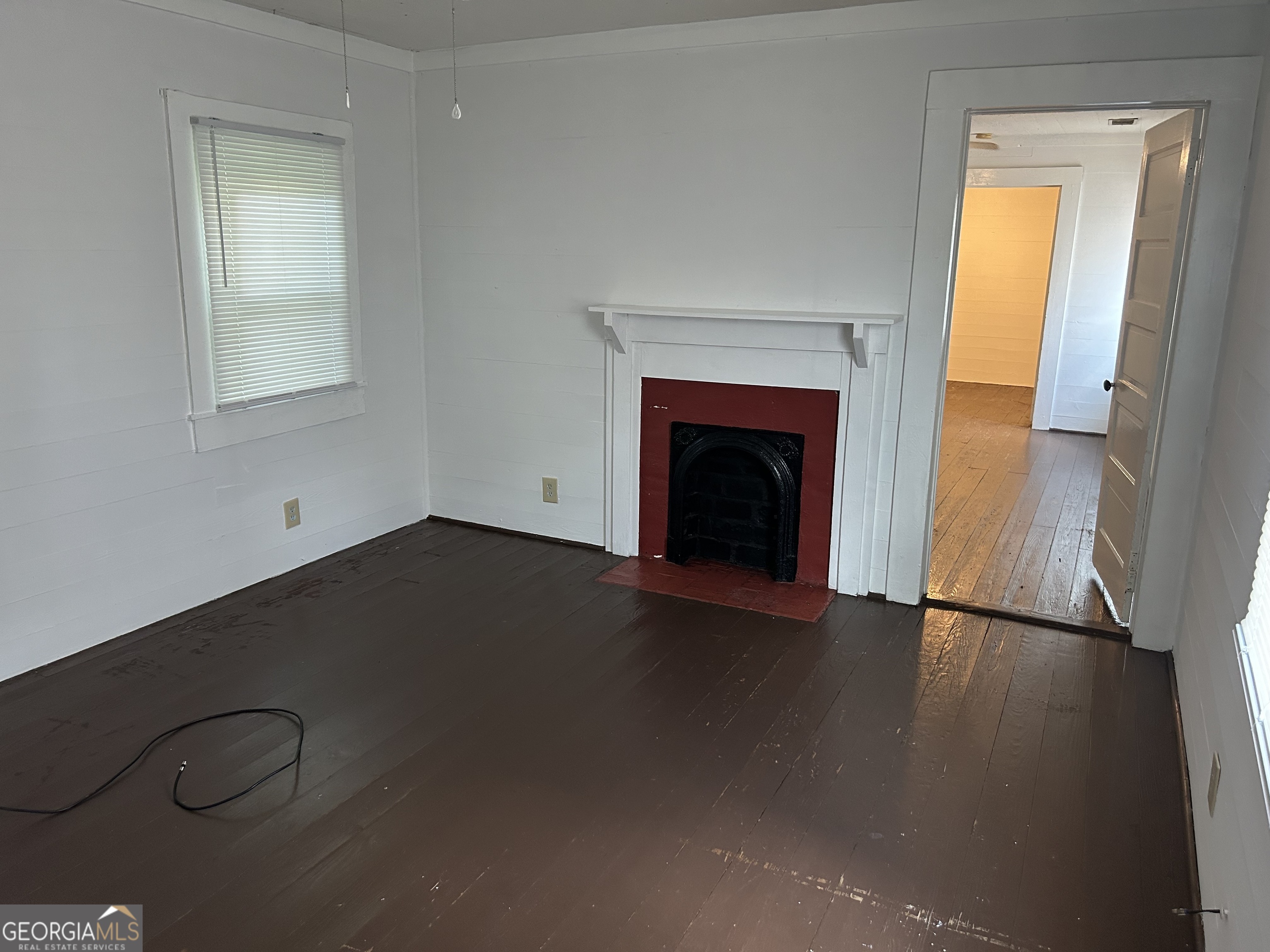 433 South Rocksprings Street Athens, GA 30605 - Photo 4 of 14 a view of empty room with wooden floor and fireplace