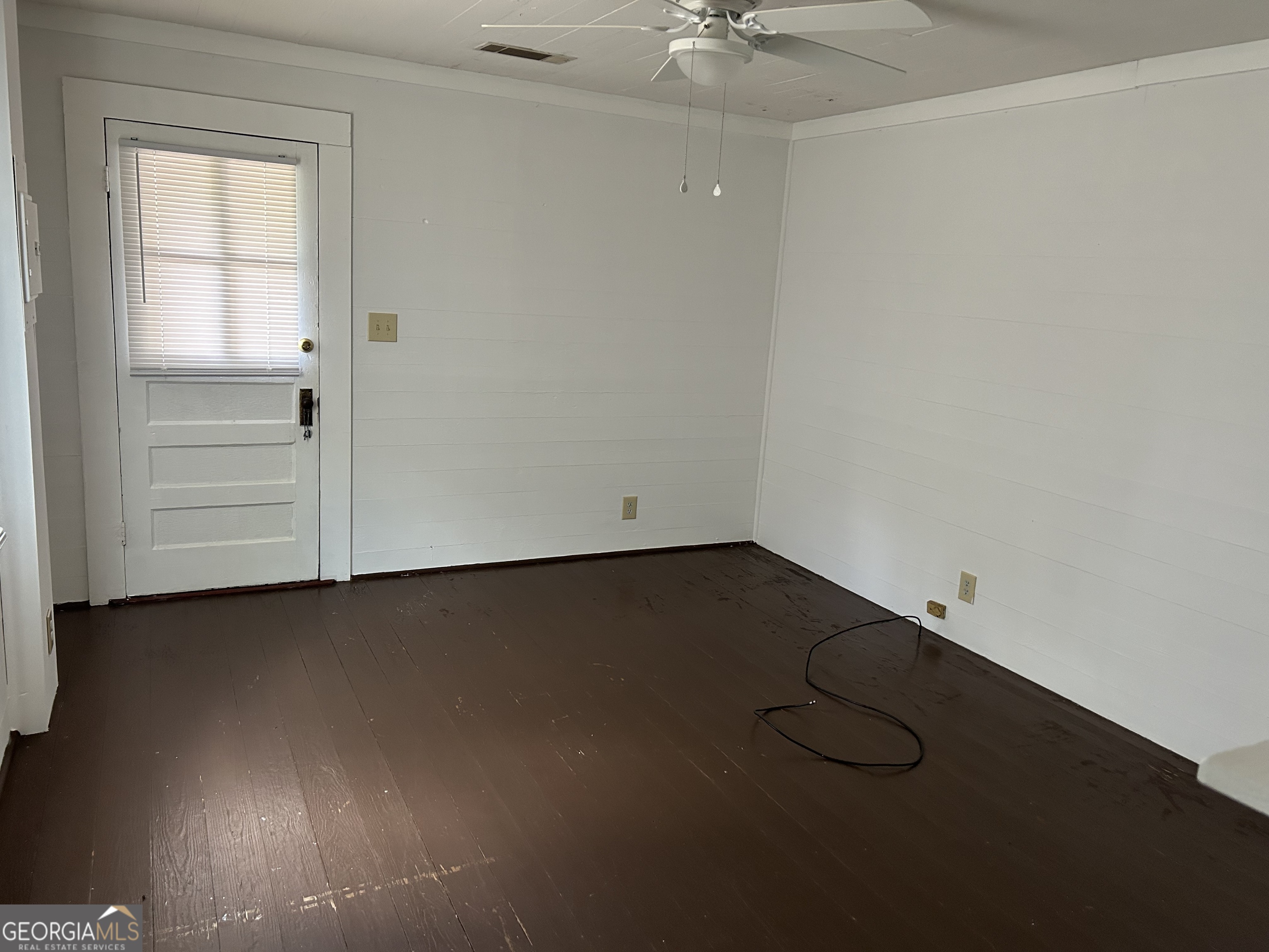433 South Rocksprings Street Athens, GA 30605 - Photo 5 of 14 an empty room with a wooden floor and windows