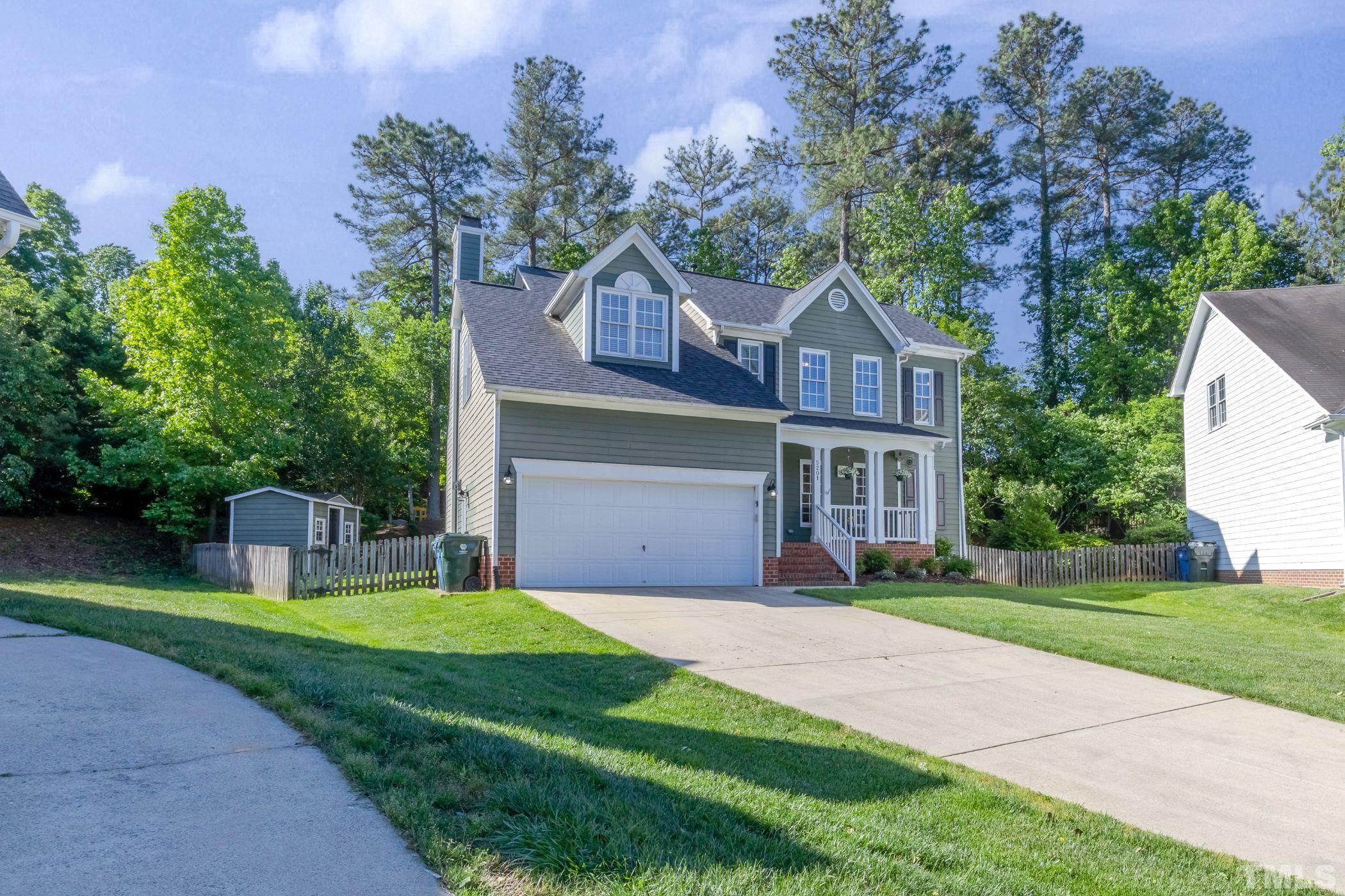 5201 Halcott Court Raleigh, NC 27613 - Photo 3 of 55 a front view of a house with garden