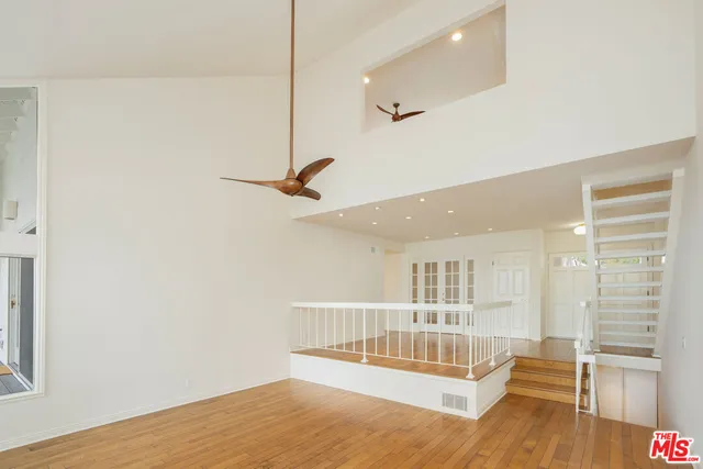 a kitchen with a stove and a wooden floor