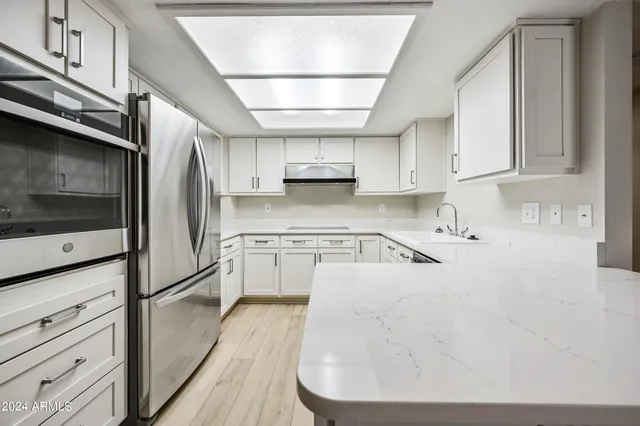 a kitchen with white cabinets and a sink