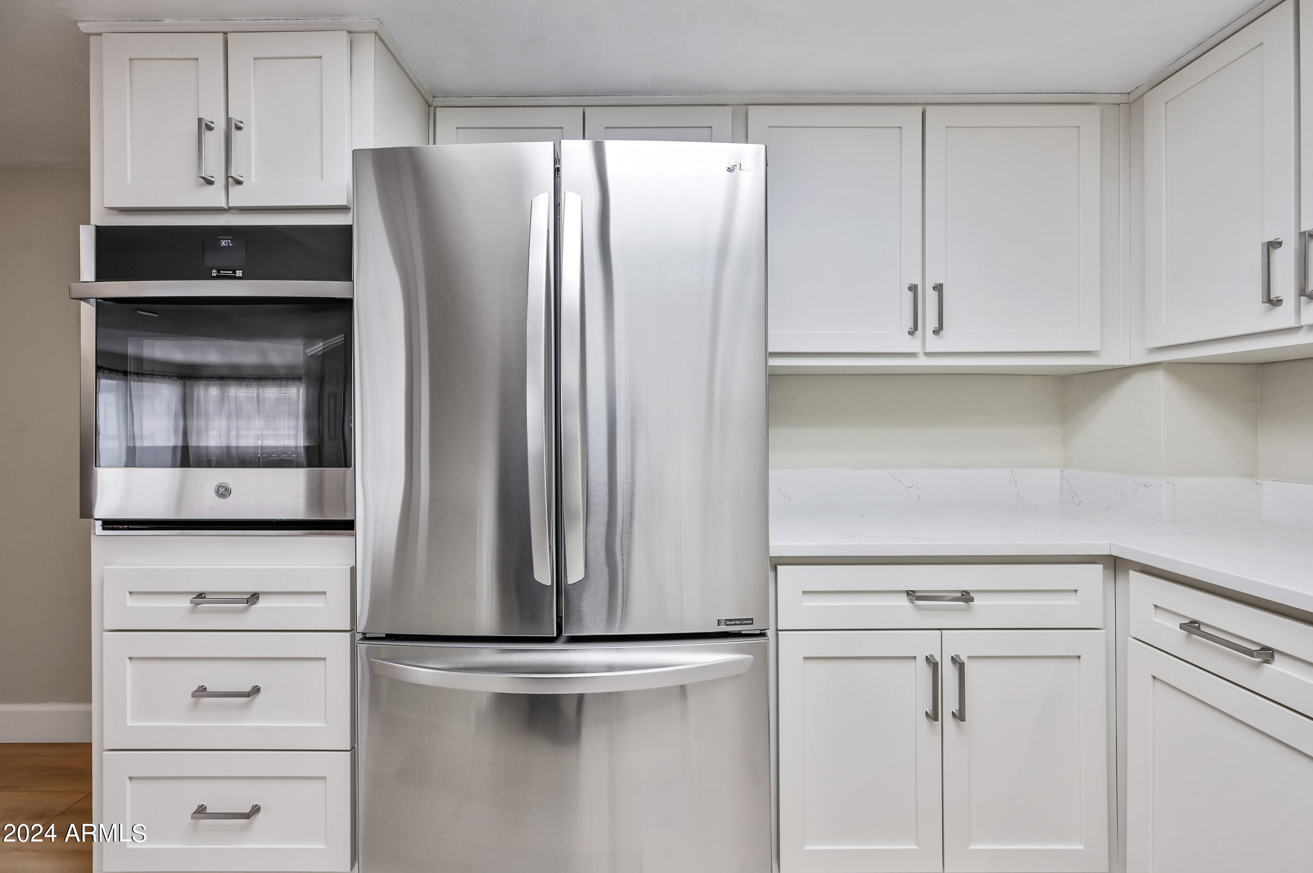 17404 North 99th Avenue, Unit 338 Sun City, AZ 85373 - Photo 17 of 27 a kitchen with white cabinets and refrigerator