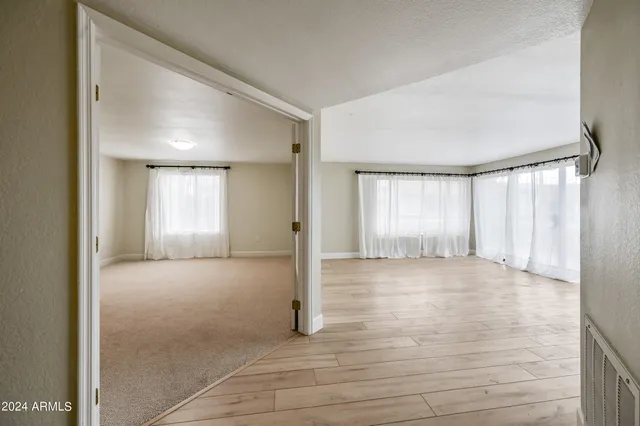 an empty room with windows and closet