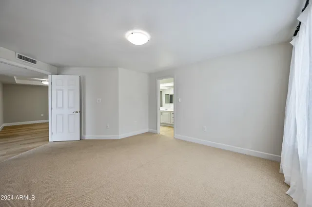 a spacious bathroom with a sink and a mirror