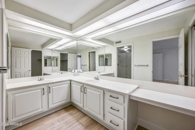 a bathroom with a double vanity sink toilet and shower