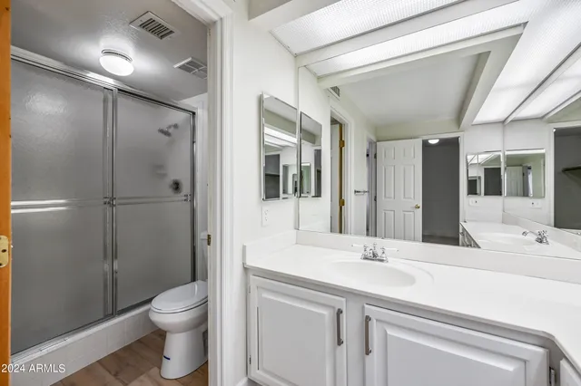 a bathroom with a sink double vanity granite and a vanity