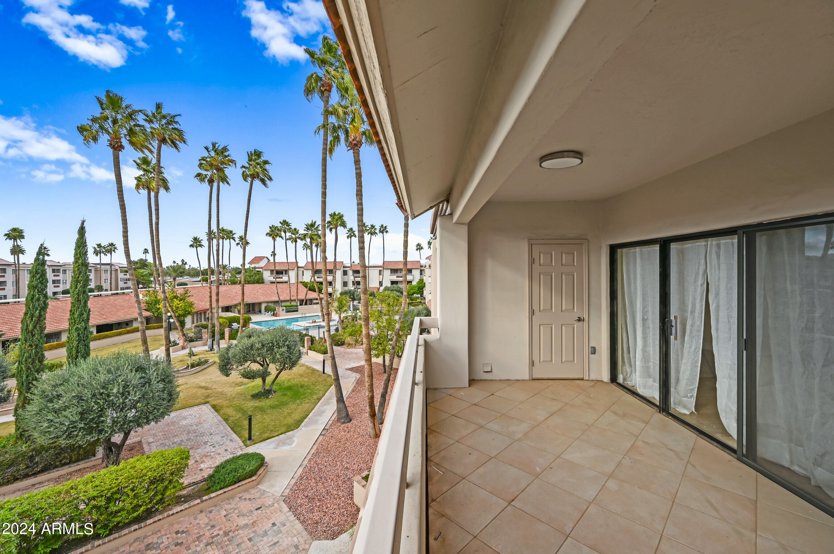 17404 North 99th Avenue, Unit 338 Sun City, AZ 85373 - Photo 10 of 27 a view of a balcony with chairs and potted plants