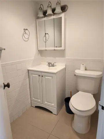 a bathroom with a toilet a sink and a mirror