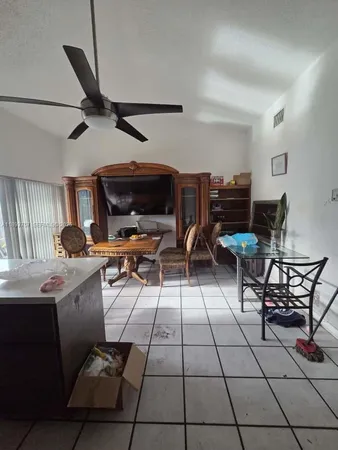 a view of kitchen with sink dining table and chairs