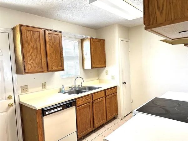 a kitchen with a sink and a refrigerator