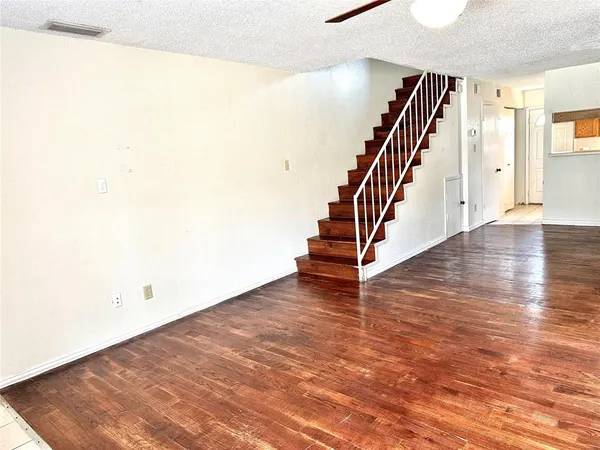 a view of an entryway with wooden floor
