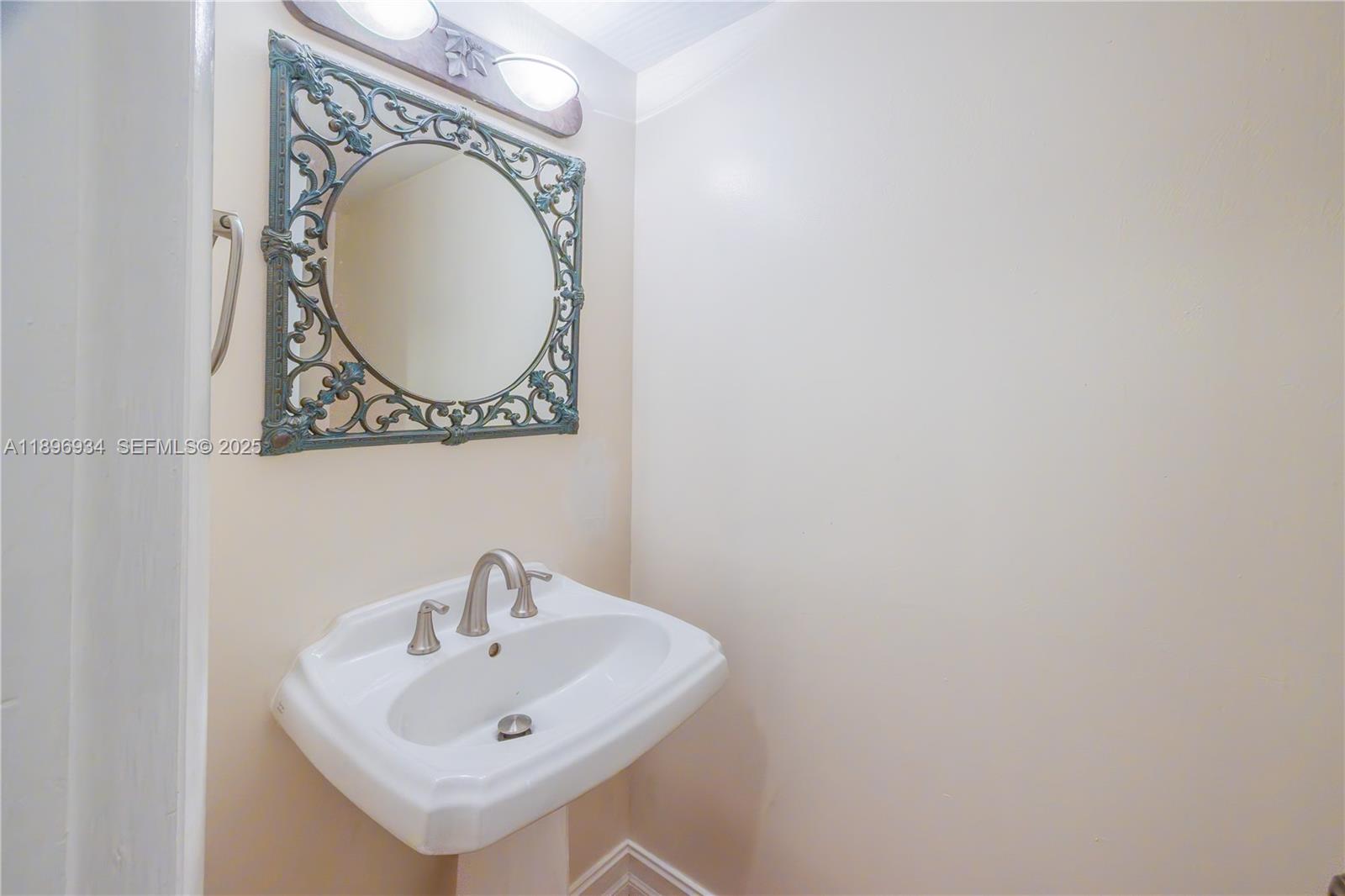 7890 Southwest 86th Street, Unit 11 Miami, FL 33156 - Photo 11 of 31 a bathroom with a sink and a mirror