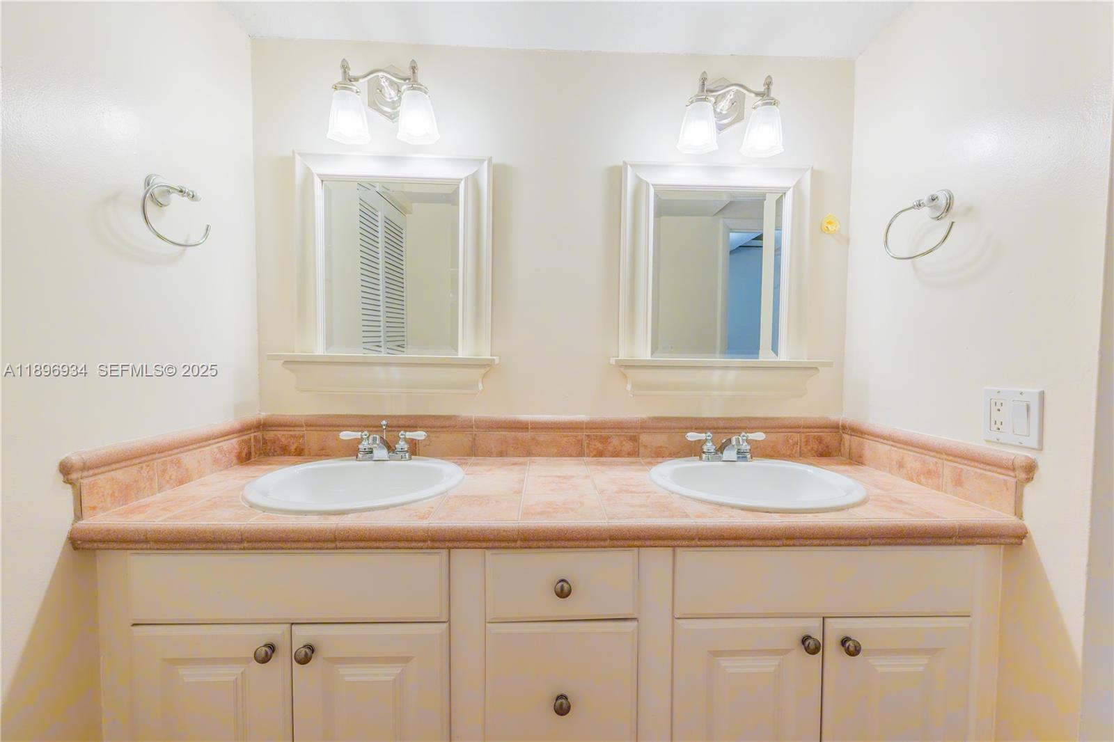 7890 Southwest 86th Street, Unit 11 Miami, FL 33156 - Photo 16 of 31 a bathroom with a sink and a mirror