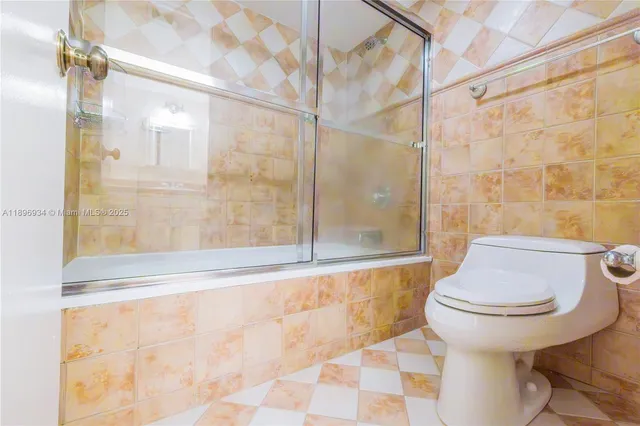 a view of a hallway with wooden floor and cabinet