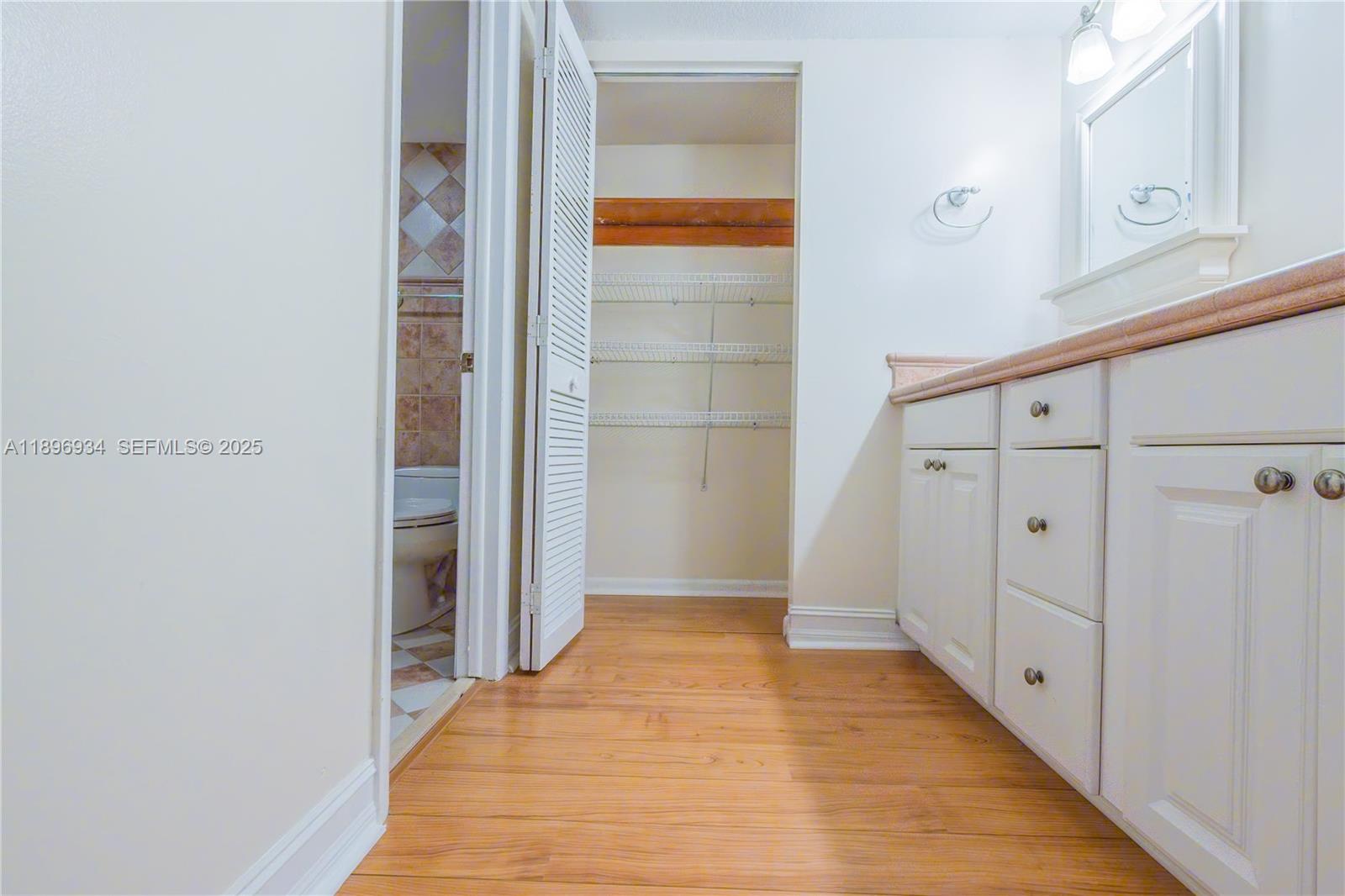 7890 Southwest 86th Street, Unit 11 Miami, FL 33156 - Photo 19 of 31 a view of a hallway with wooden floor and cabinet