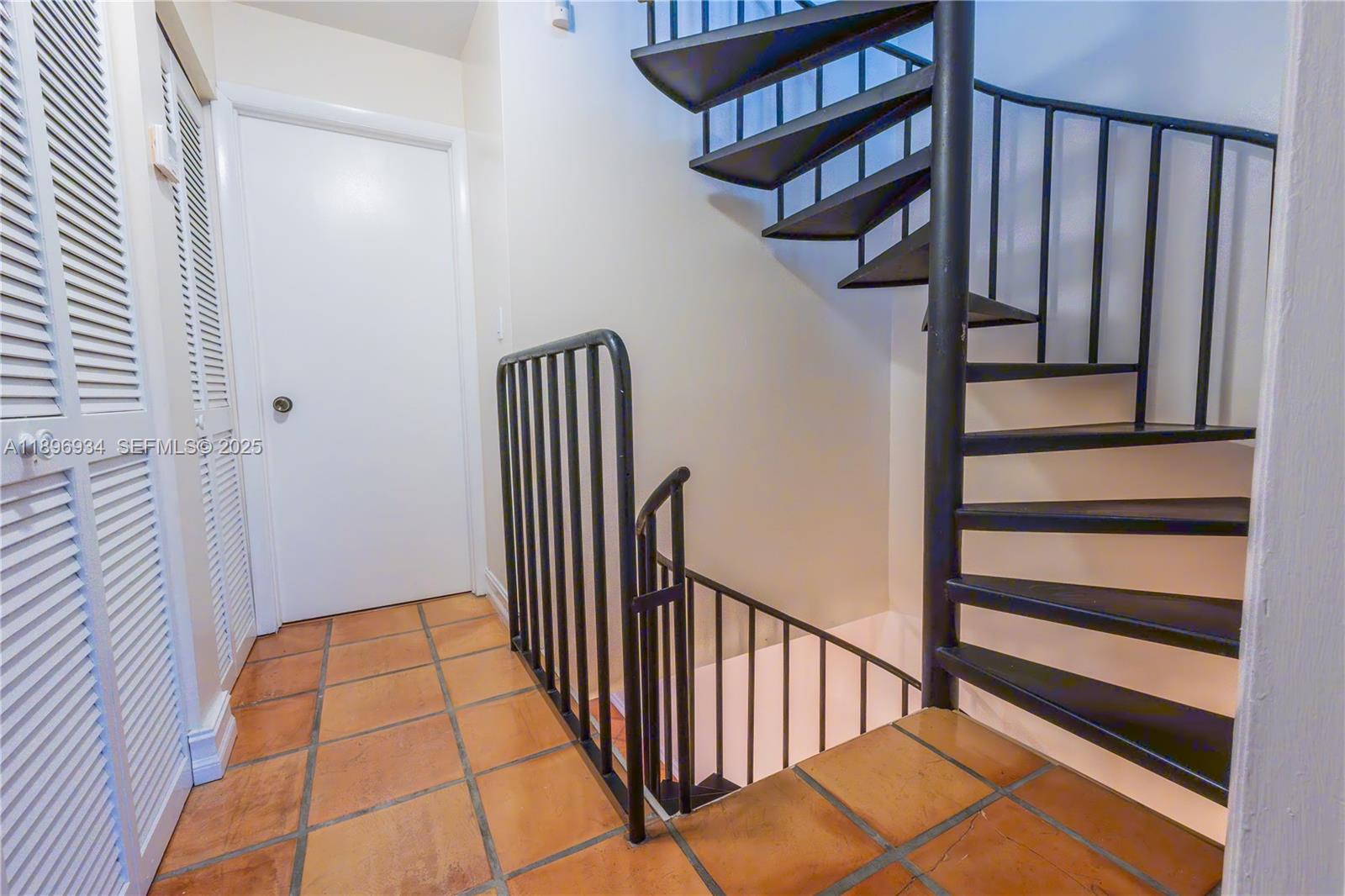 7890 Southwest 86th Street, Unit 11 Miami, FL 33156 - Photo 24 of 31 a view of a hallway with wooden floor and staircase