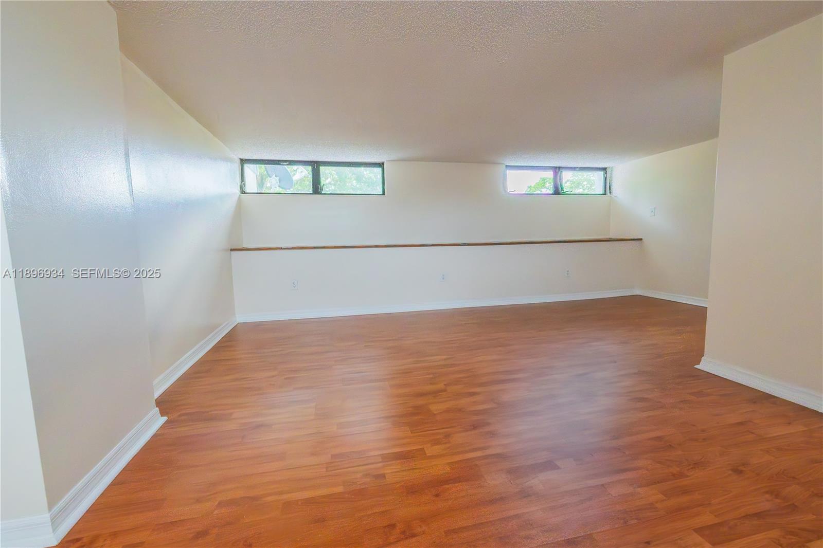 7890 Southwest 86th Street, Unit 11 Miami, FL 33156 - Photo 25 of 31 a view of empty room with wooden floor