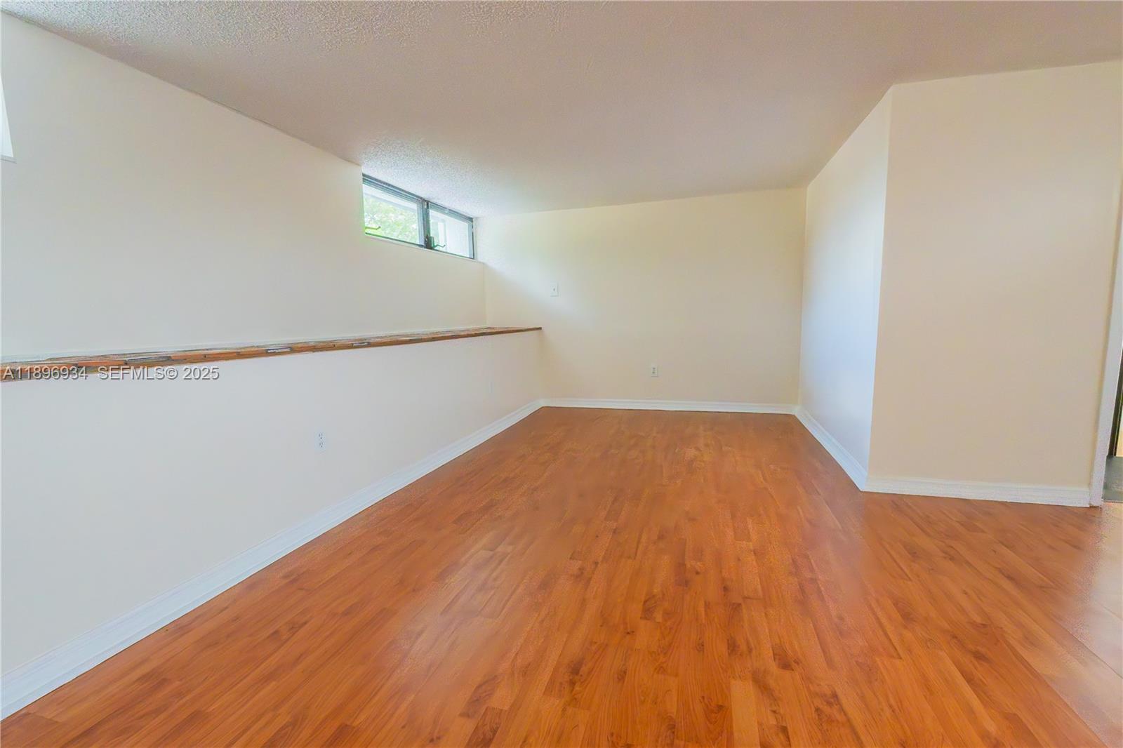 7890 Southwest 86th Street, Unit 11 Miami, FL 33156 - Photo 26 of 31 a view of empty room with wooden floor